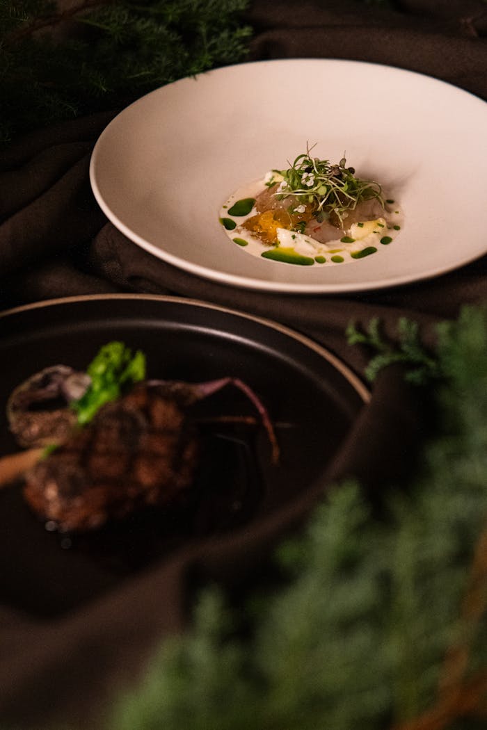 menu-03 Close-up of elegantly plated fine dining dishes at a Tokyo restaurant, showcasing culinary artistry.